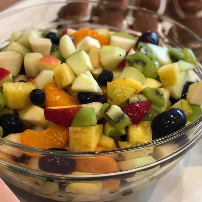 Bunte Mischung aus verschiedenen Obstsorten, darunter Äpfel, Melonen und Orangen.